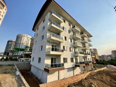 Апартаменты 1+1 с видом на горы в районе Махмутлар фото 1