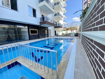 Апартаменты 1+1 с видом на горы в районе Махмутлар фото 3